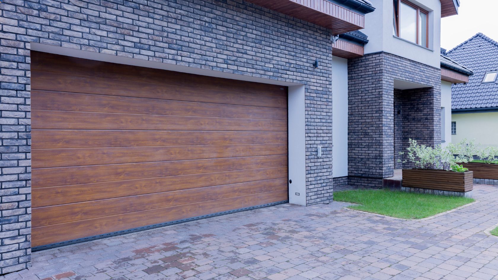 A brick house with a wooden garage door