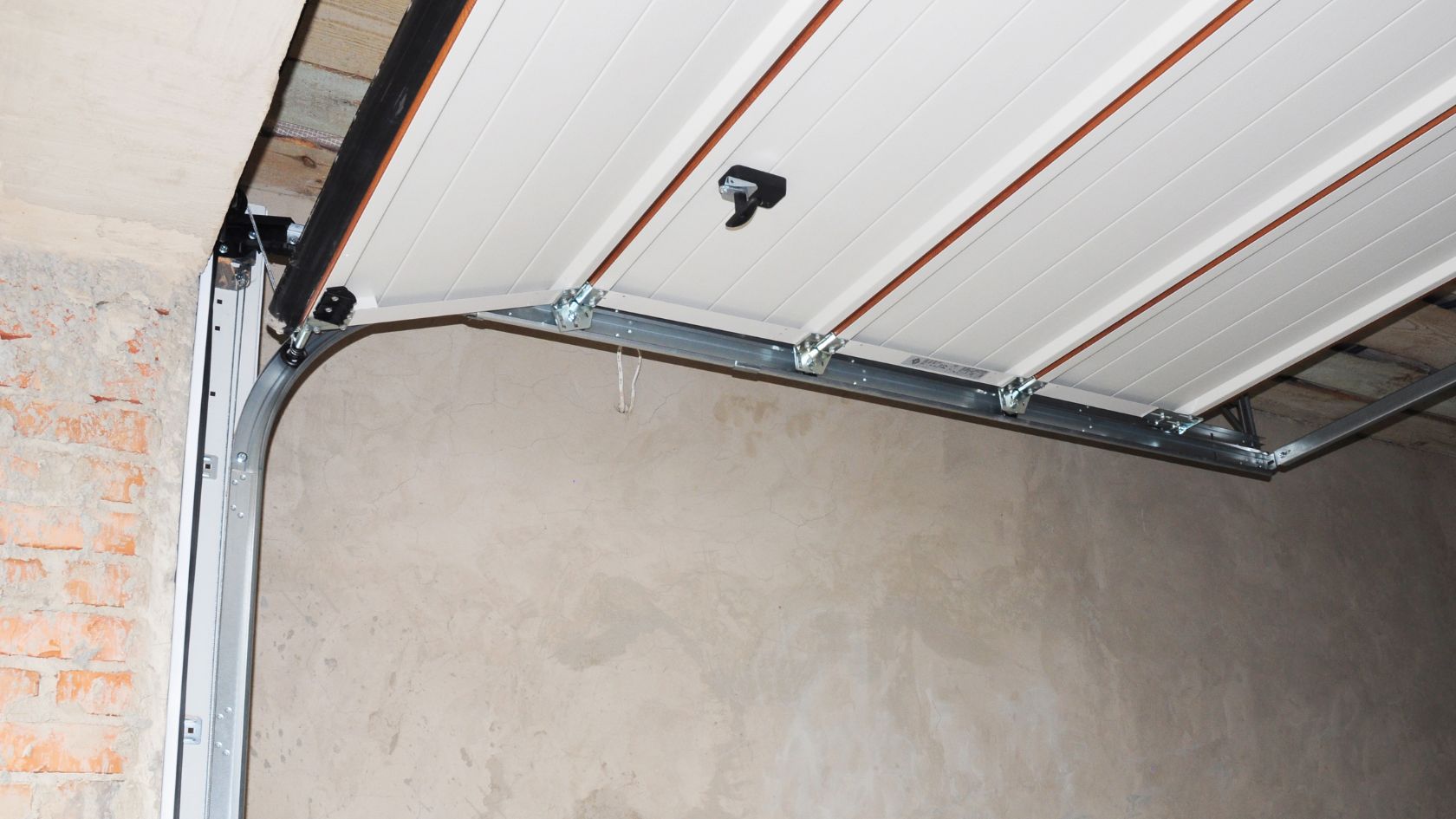 A white garage door with a black handle