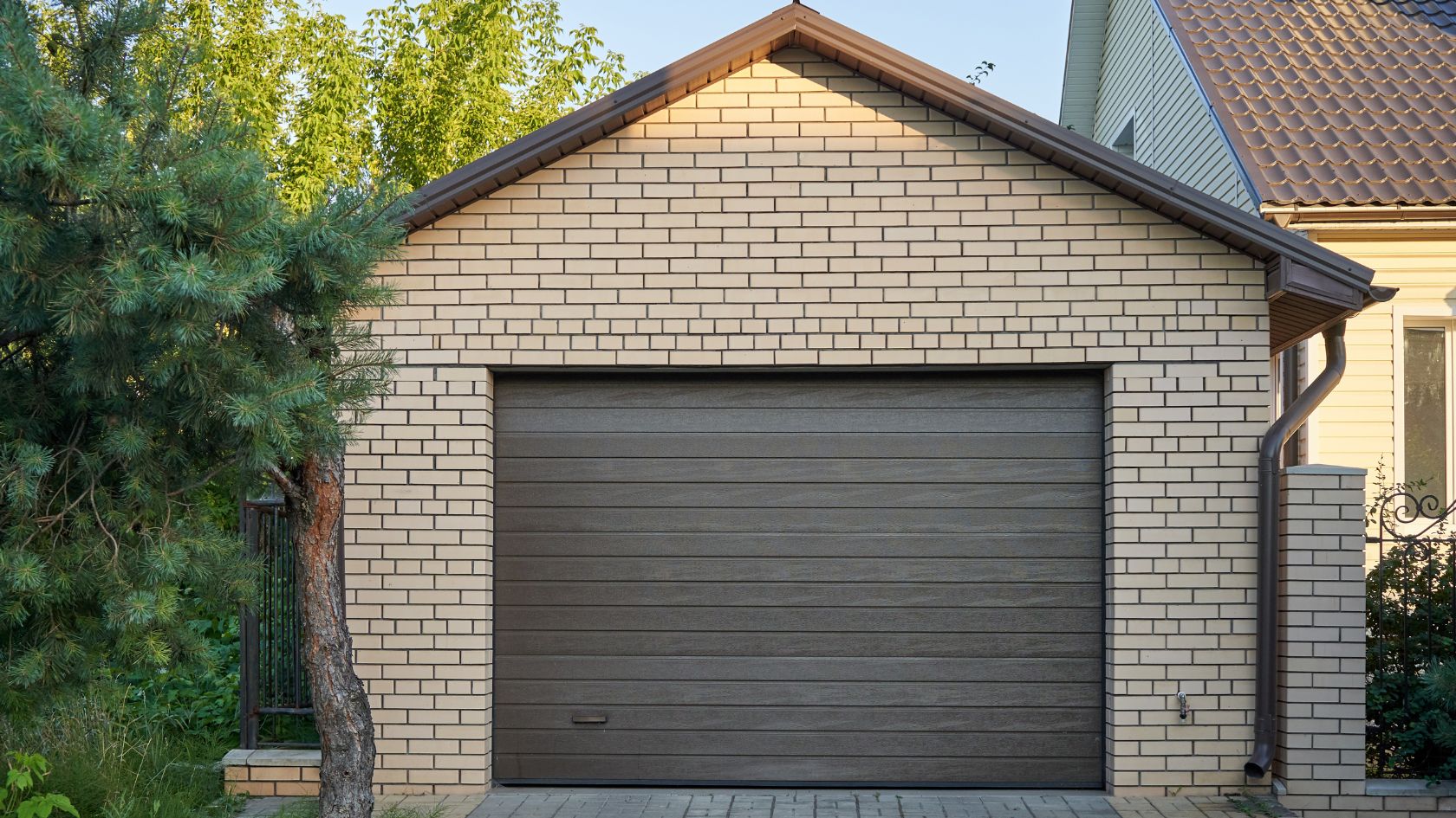 A brick house with a large garage door